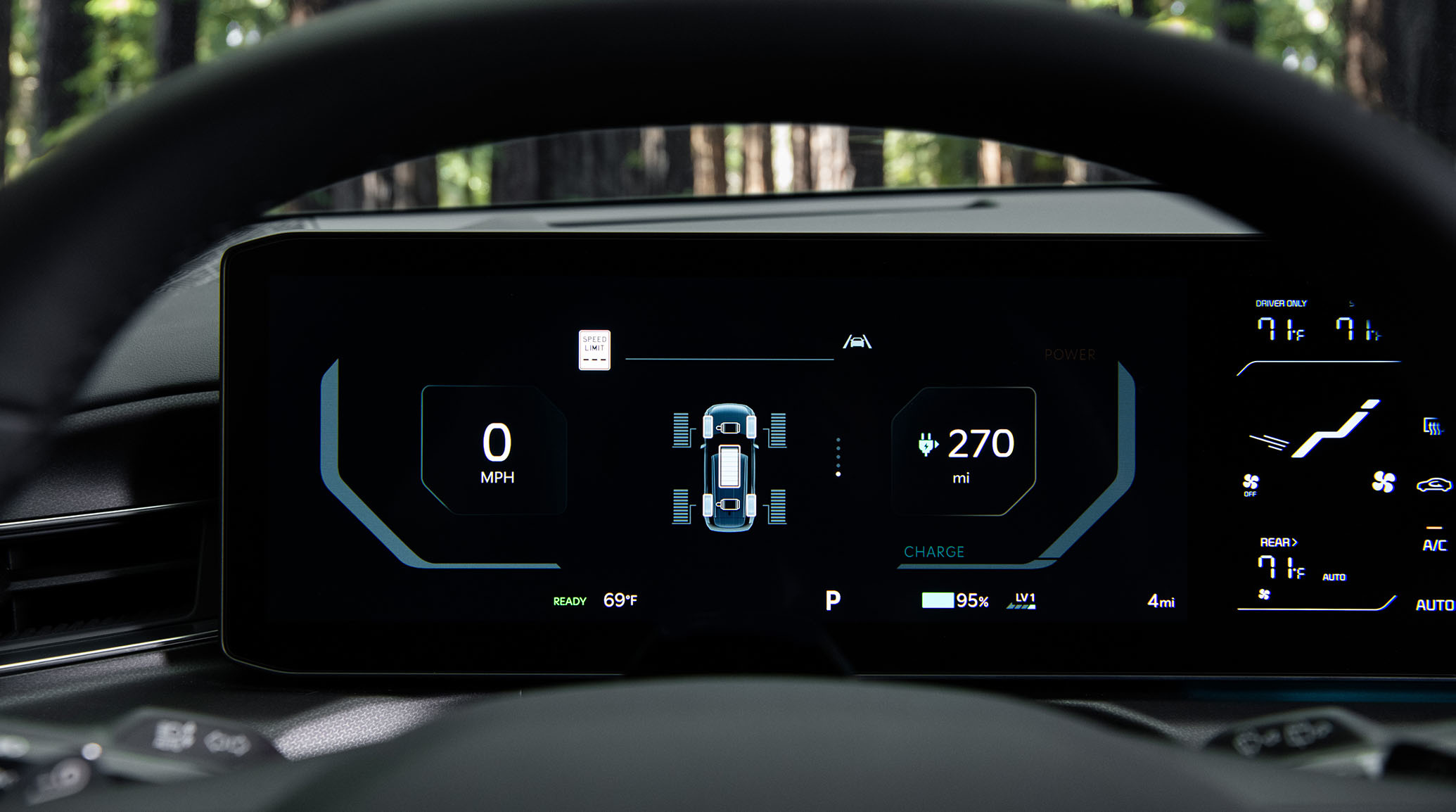 2024 Kia EV9 interior, zoomed in view of the digital dashboard with the miles until next charge, miles per hour, and tire health showing on the screen