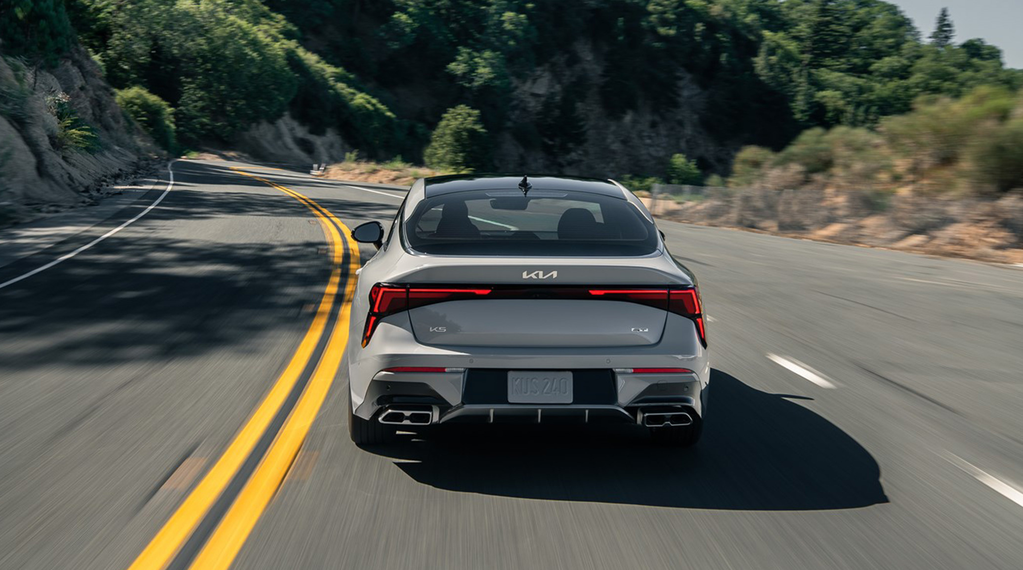 A rear view of the 2025 Kia K5 showing off the Kia badge and taillights