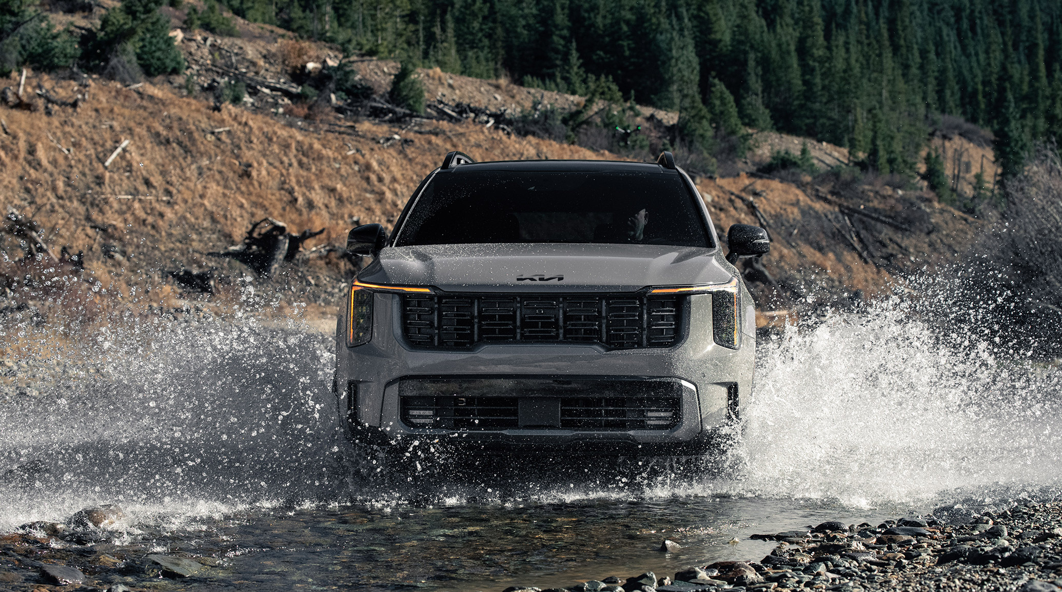 2025 Kia Sorento, front view, driving through a river making a big splash