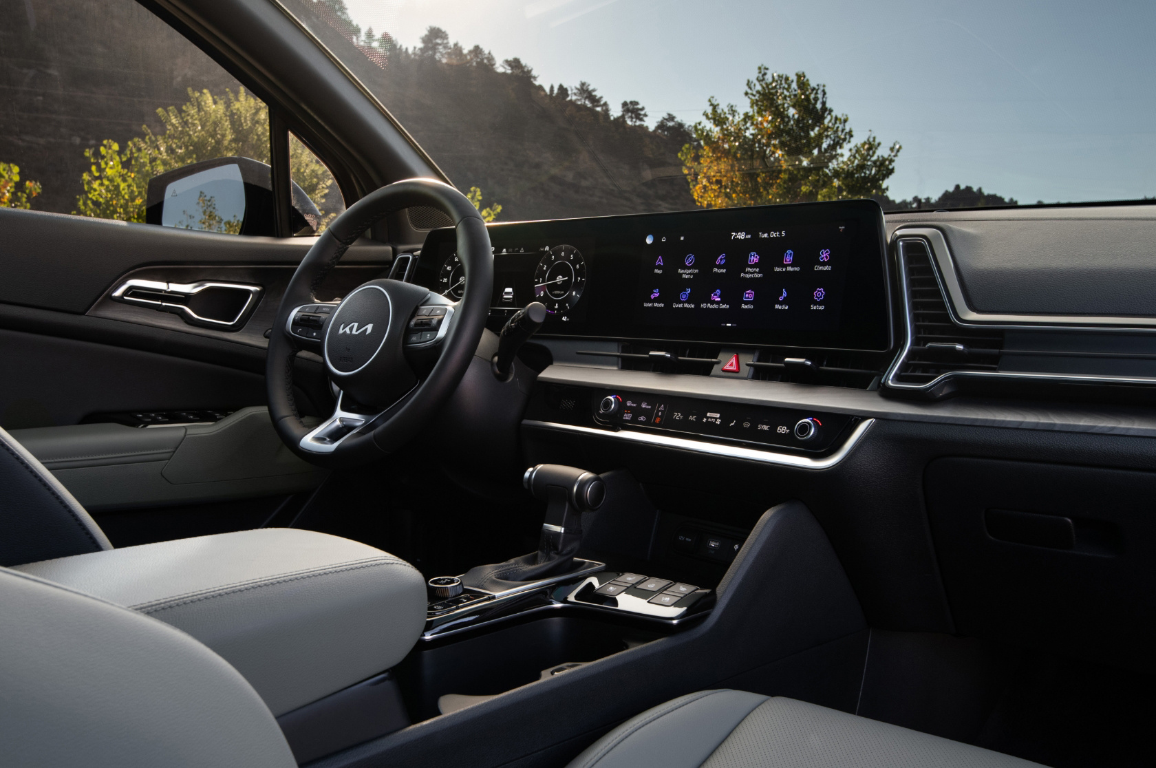 2025 Kia Sportage interior, three-quarter view of the driver cockpit featuring the dual panoramic display