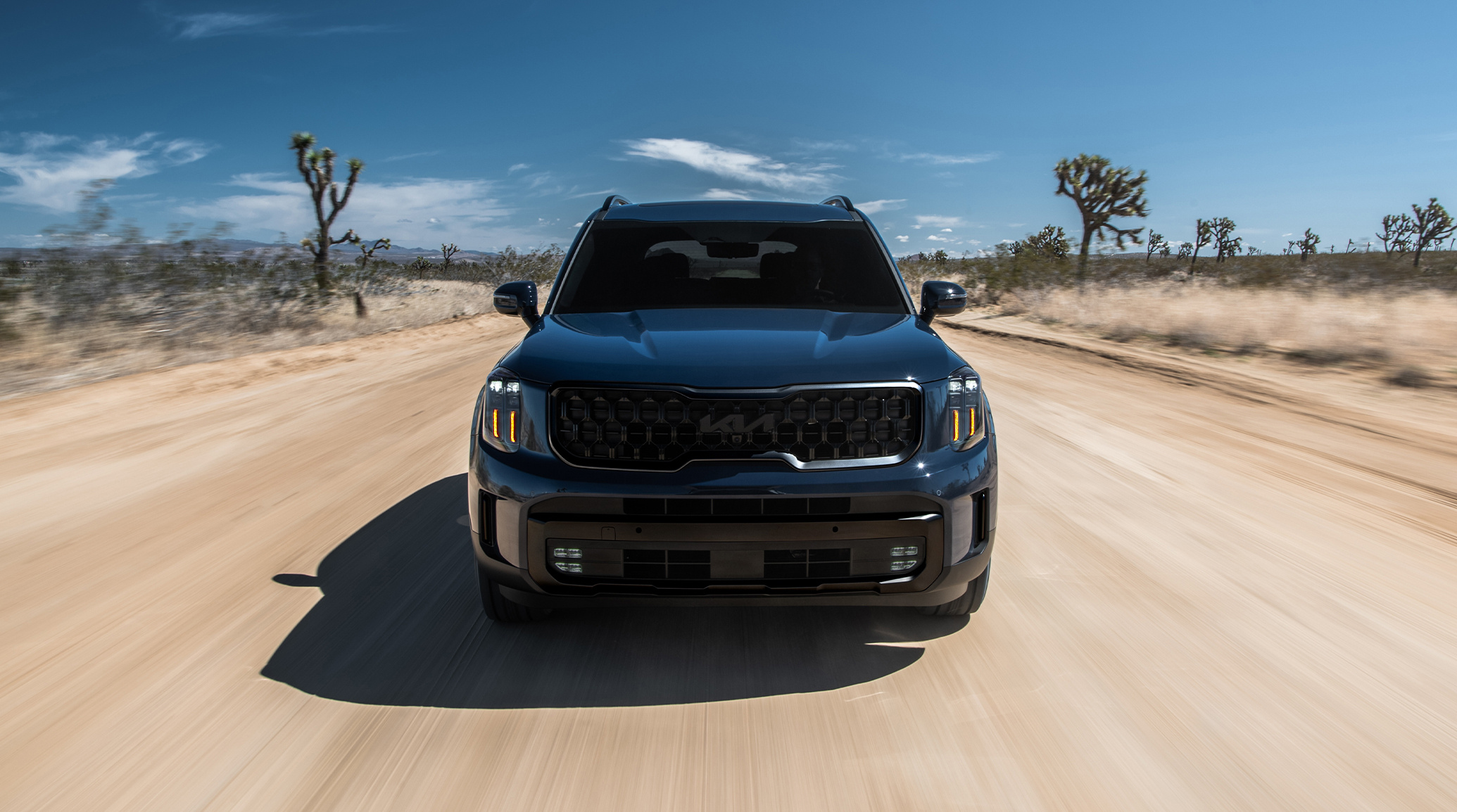 2025 Kia Telluride X-Line, front view, driving down a desert road