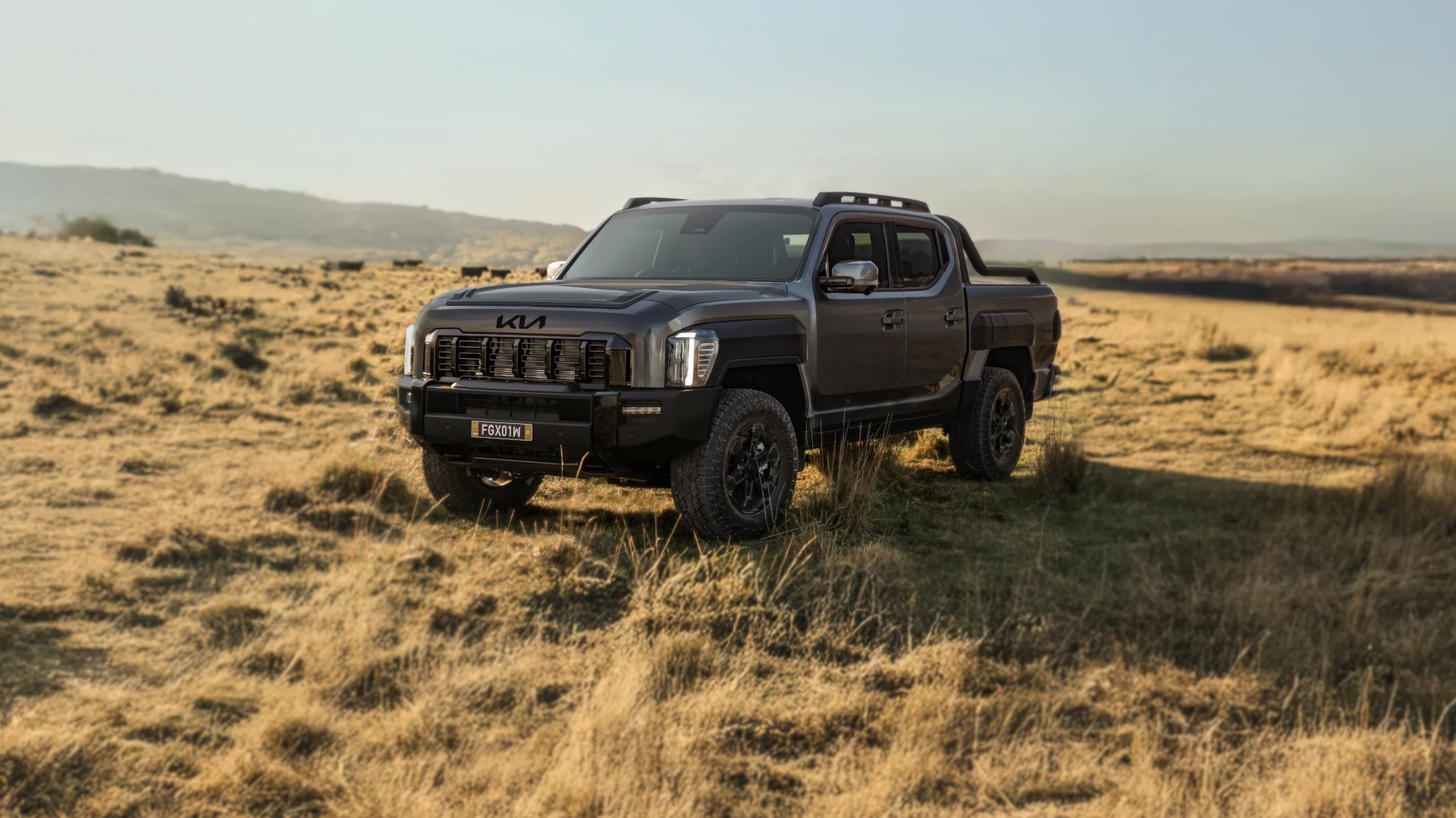 Kia Tasman front view parked in fields