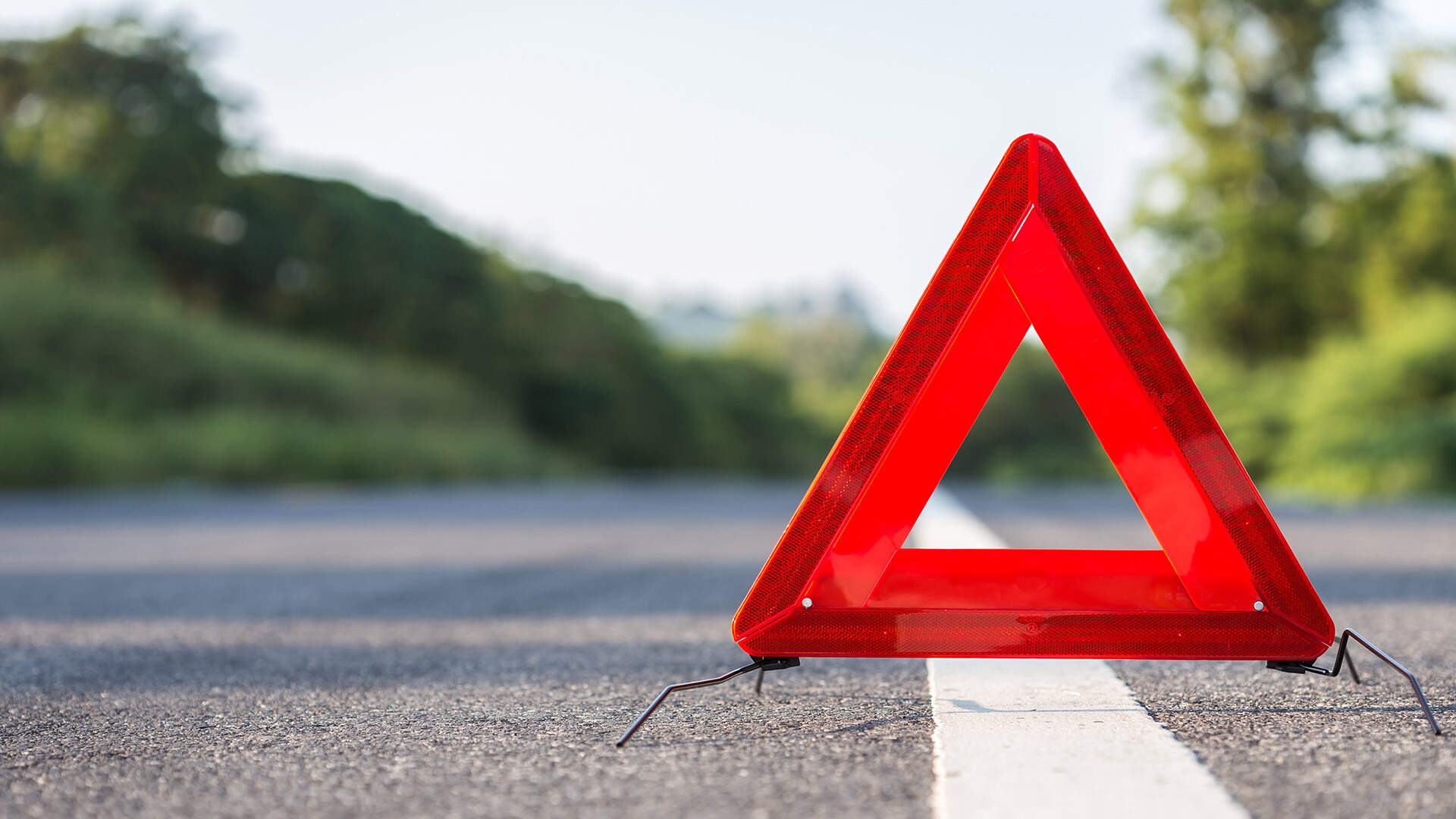 Emergency warning triangle sign on the road