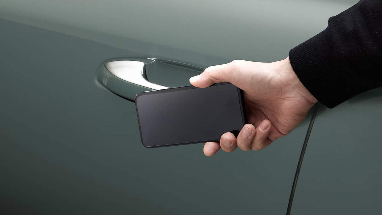 Mobile phone which acts as a key being placed near the handle of a car
