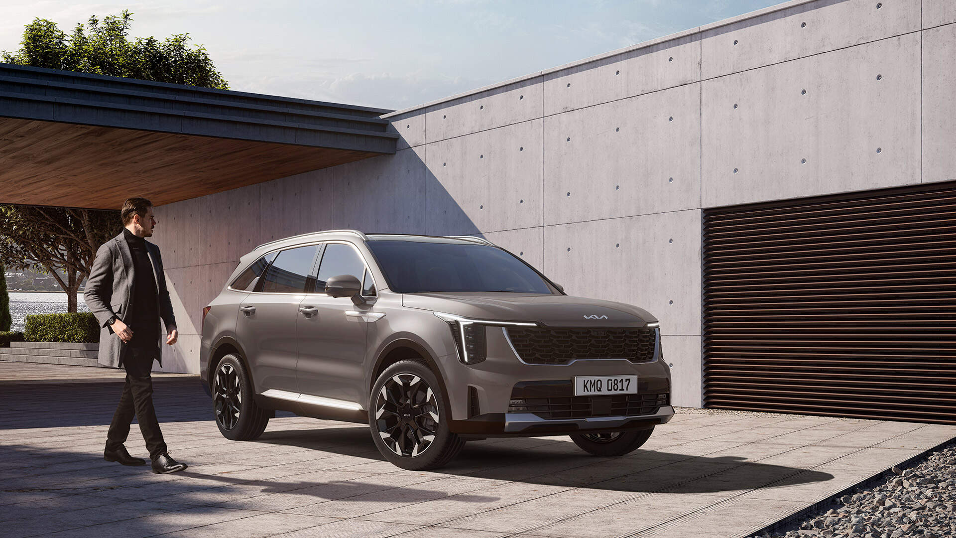 Stroll alongside the Kia Sorento, poised in front of a striking backdrop, embodying sophistication and urban charm