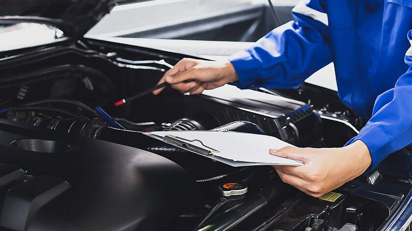 Mechanic inspecting a car engine