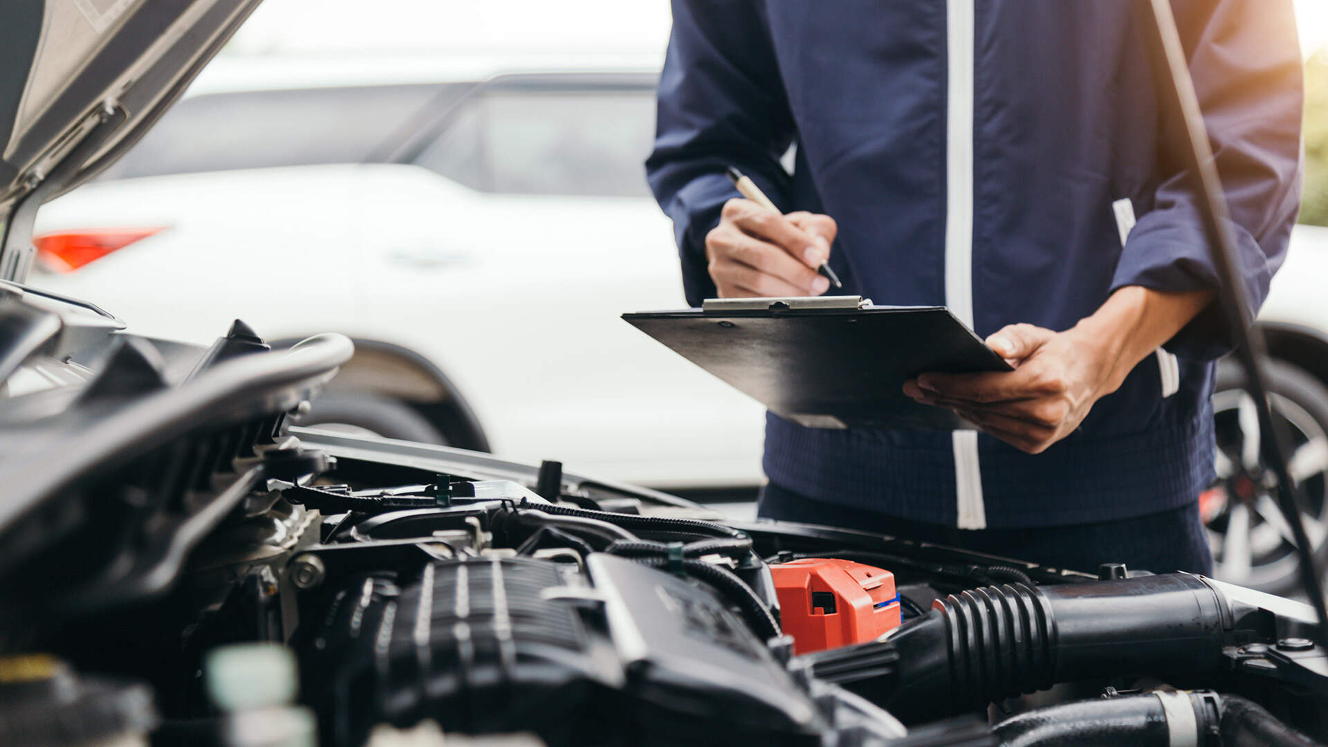 Mechanic is inspecting a car engine