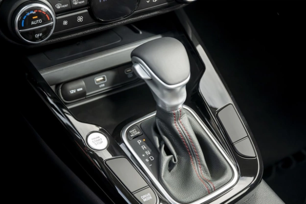 2025 Kia Soul interior, zoomed in view of the gear shifter, featuring the engine start button beside it